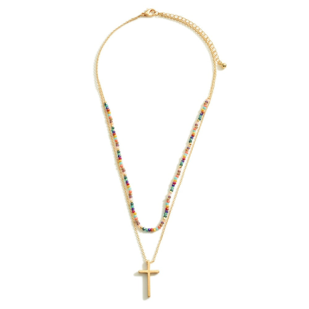 Layered Gold Necklace Featuring a Cross Pendant and Beaded Accents.